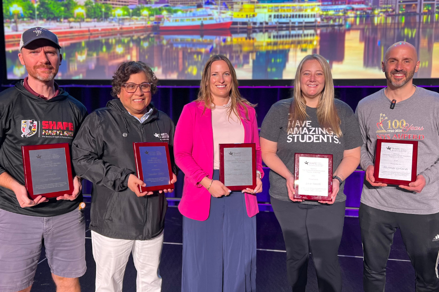 Photo of UW-Whitewater alums Sandee Ortiz, second from left, and Courtney Lukasavitz, center, who were among the five teachers honored as 2025 SHAPE America National Teachers of the Year.