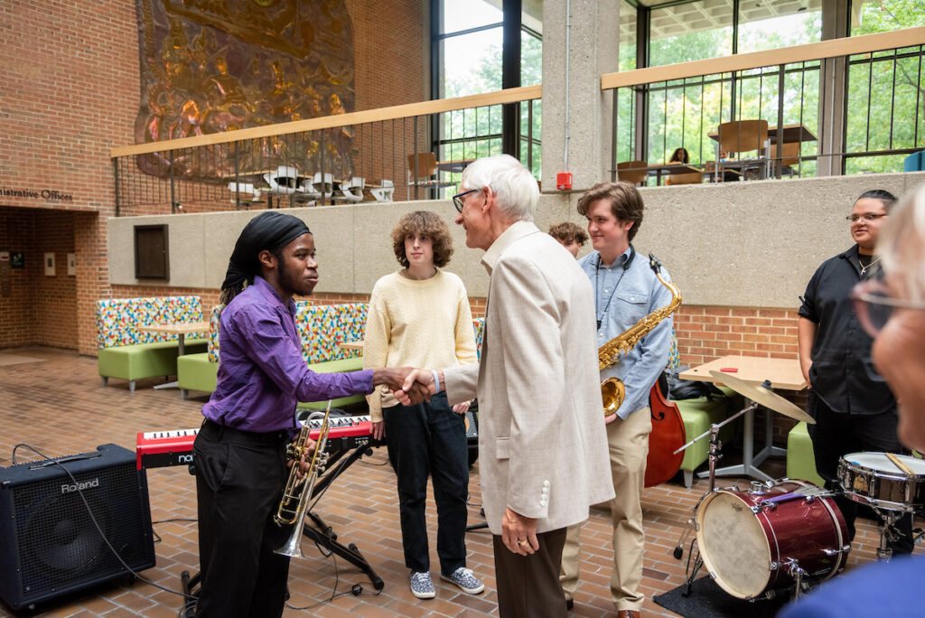 Photo of UW-Parkside music student Jerome Porter greeting Governor Tony Evers