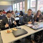 Universities of Wisconsin participants smiling and giving thumbs up at the May 2, 2025, Shared Governance Council meeting at the Pyle Center in Madison, Wisconsin.