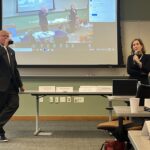 Universities of Wisconsin System Regent President Amy Bogost addressing the May 2, 2025, Shared Governance Council meeting and President Jay Rothman drinking a soda at the Pyle Center in Madison, Wisconsin.