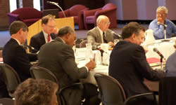 Regent President Marcovich (back, right from center) addresses the board at Friday's meeting.