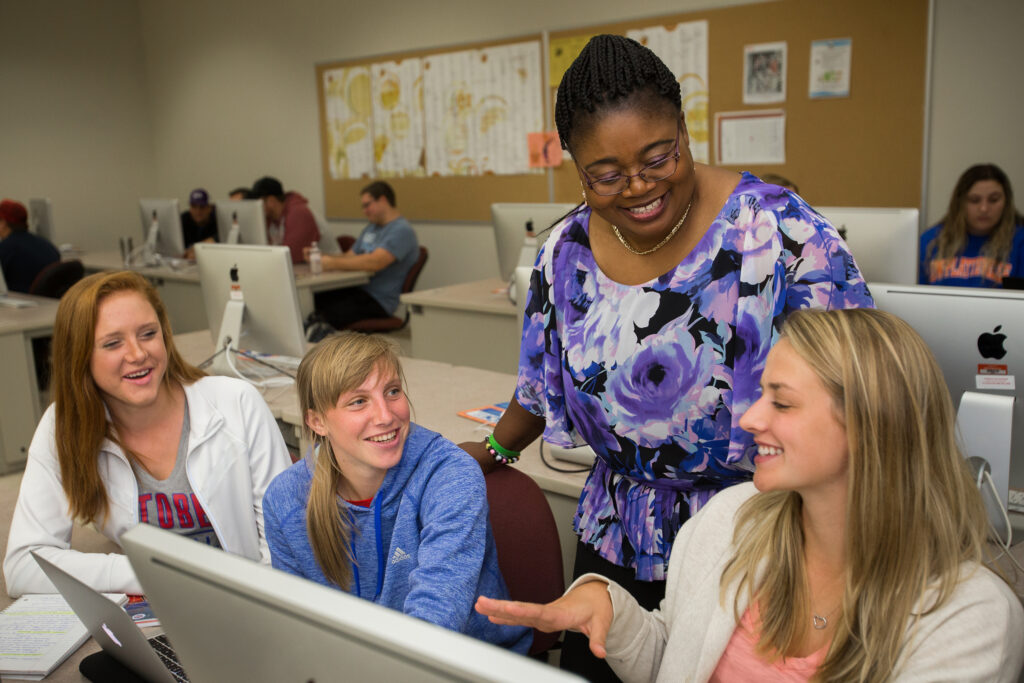 Photo of UW-Platteville students gathered around computer